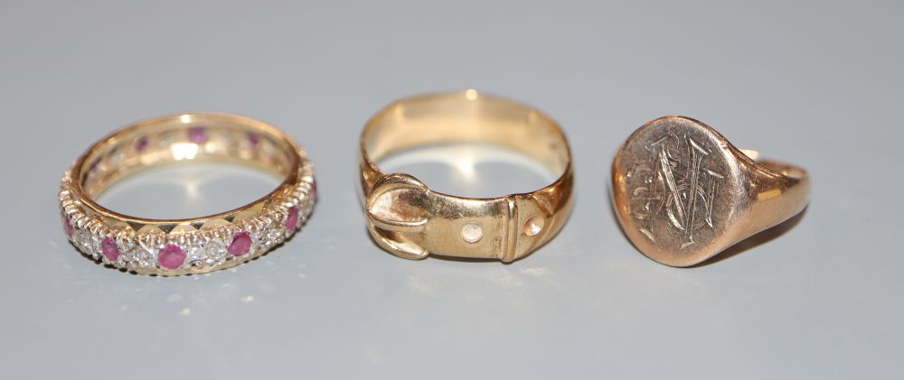 A 9ct signet ring(a.f.), a 9ct gold ruby and diamond eternity ring and a 9ct gold buckle ring, gross 10.3 grams.